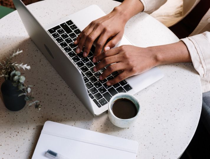 Student writing on laptop